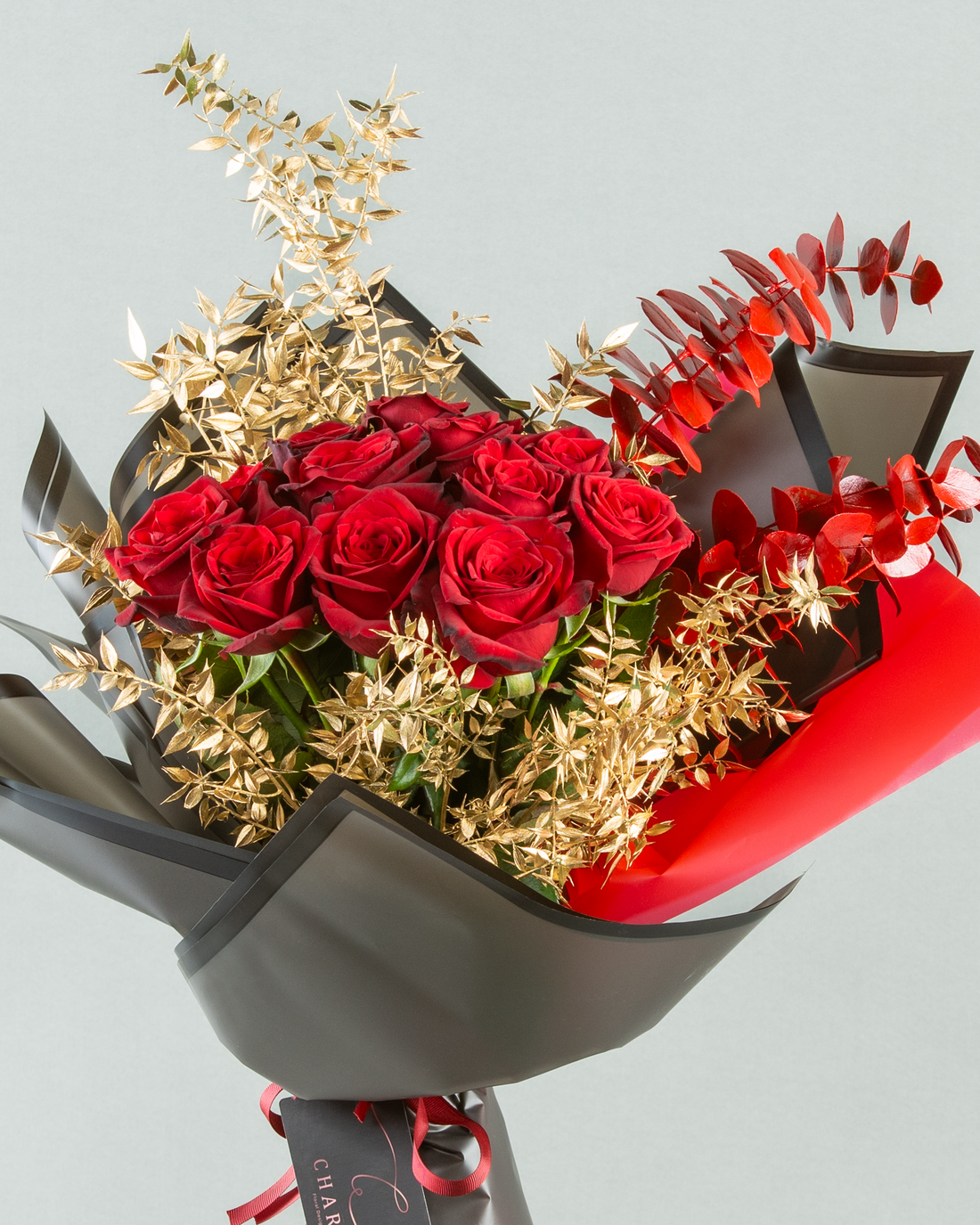 Crimson Elegance: 12 Red Roses with Painted Eucalyptus and Gold Italian Ruscus