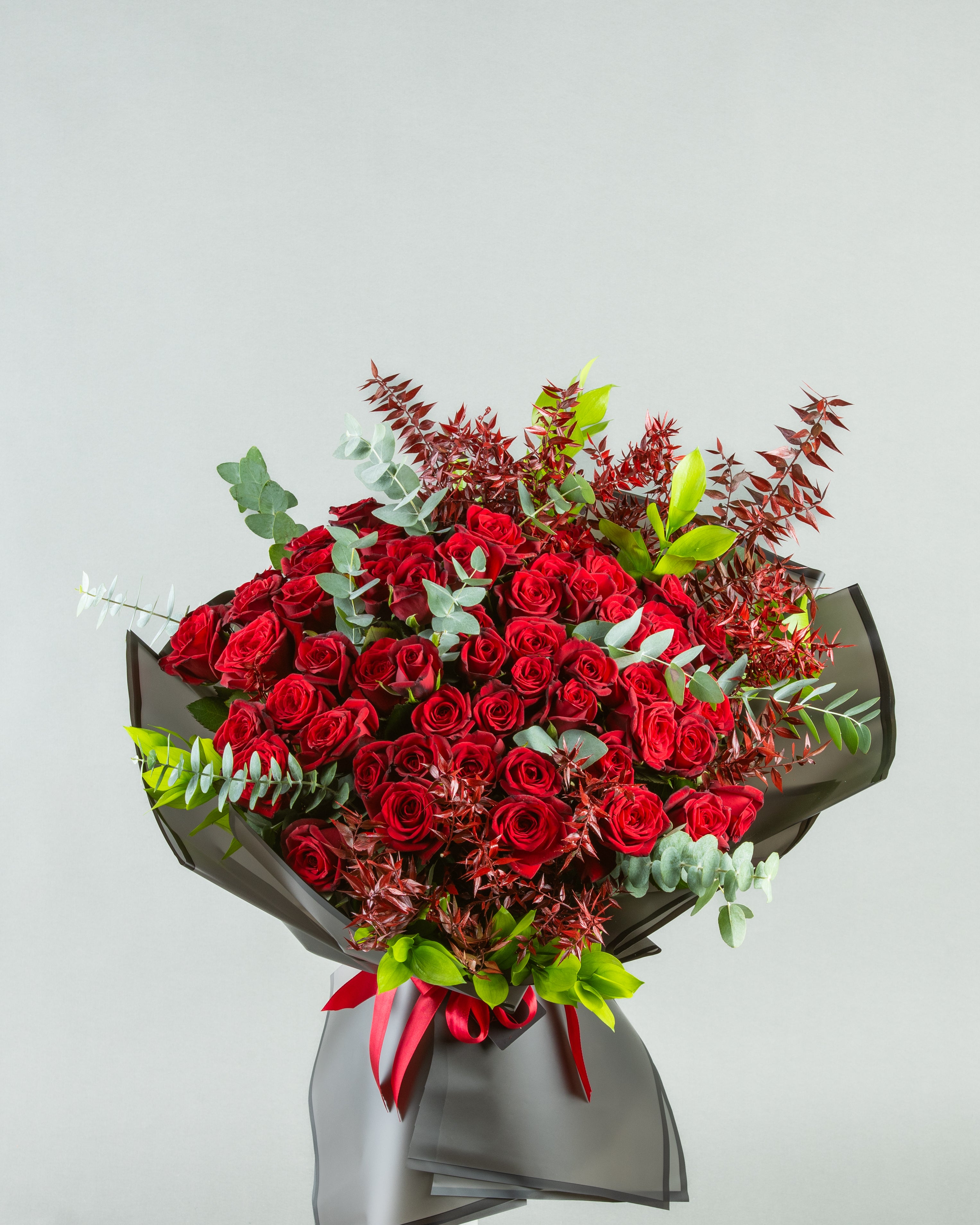 Crimson Harmony: 60 Red Roses with Painted Eucalyptus and Italian Ruscus