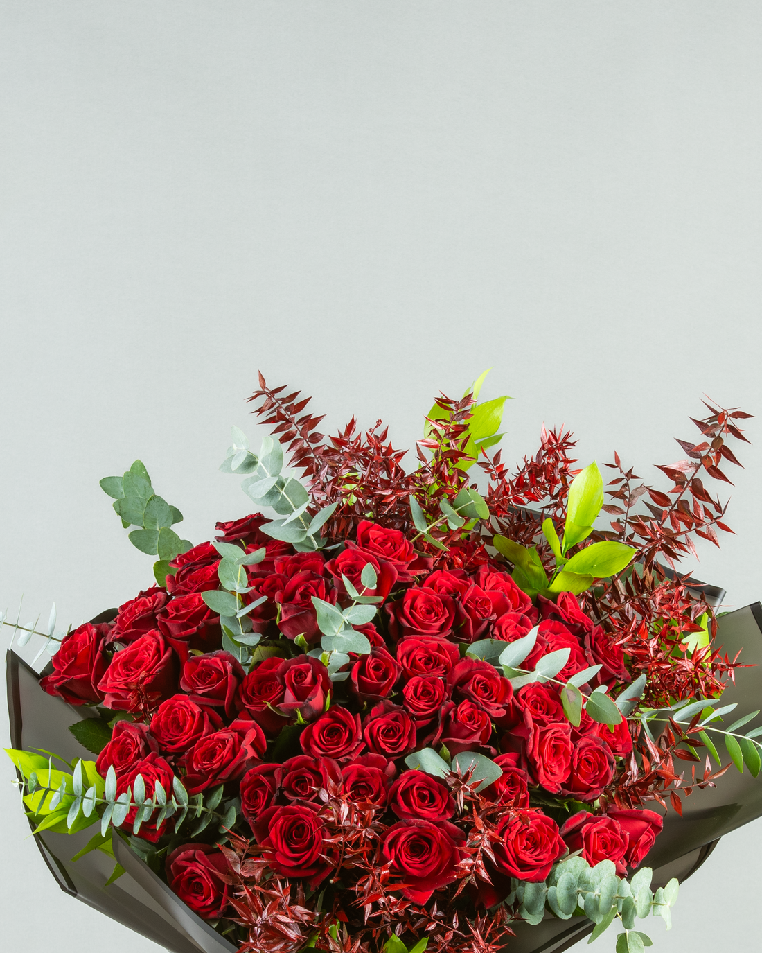 Crimson Harmony: 60 Red Roses with Painted Eucalyptus and Italian Ruscus