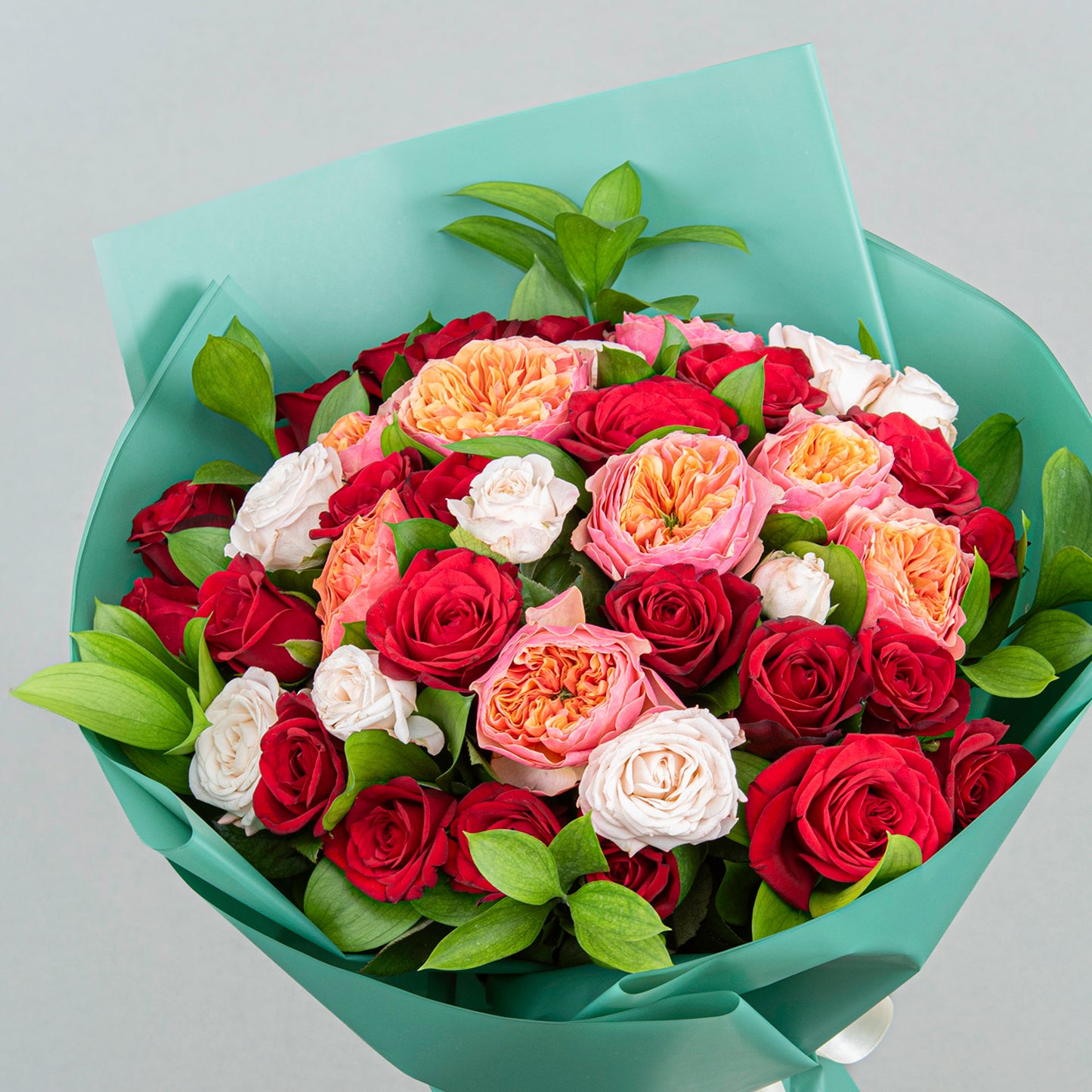 A Timeless and Elegant Bouquet made from Two Dozen Red Flowers with English Roses, Light Pink Bobby Roses, and Greenery