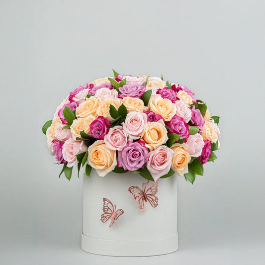 A Burst of Joy imade from 60 Colorful Blooms with Greenery in Elegant White Box