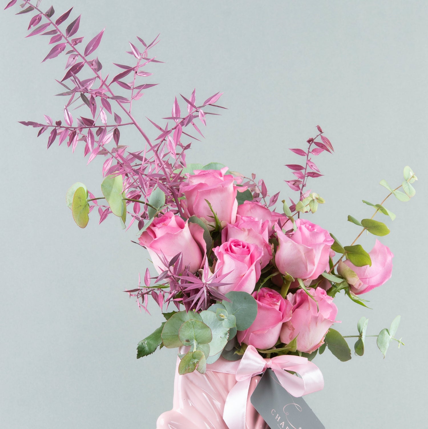 Whimsical Foliage: Fuchsia Roses in Pink Leaf-Shaped Vase