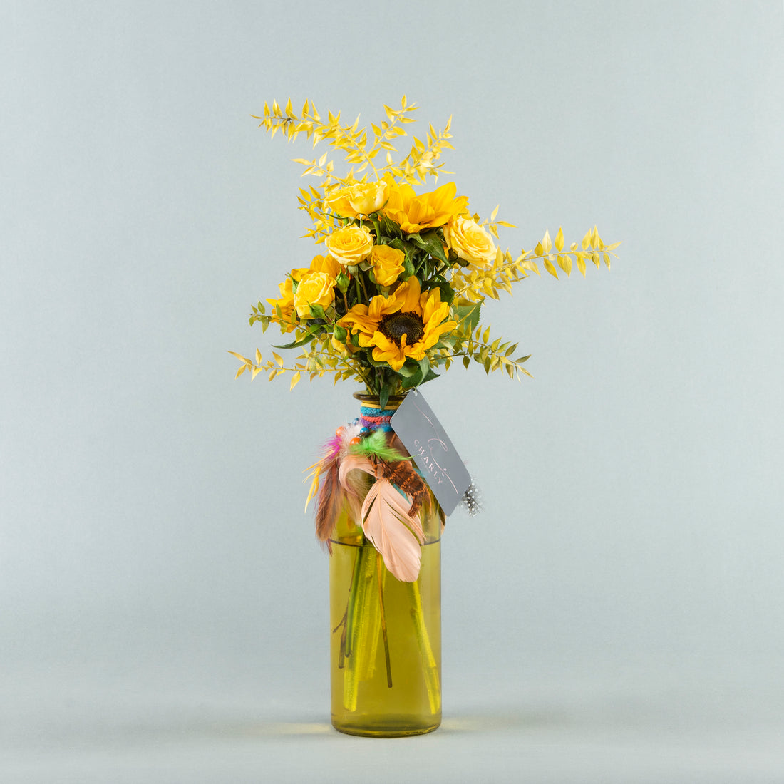 Sunshine Serenade: Yellow Bottle with Sunflower and Baby Roses