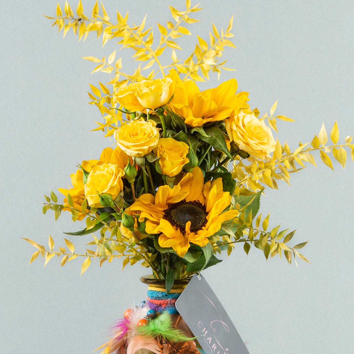 Sunshine Serenade: Yellow Bottle with Sunflower and Baby Roses