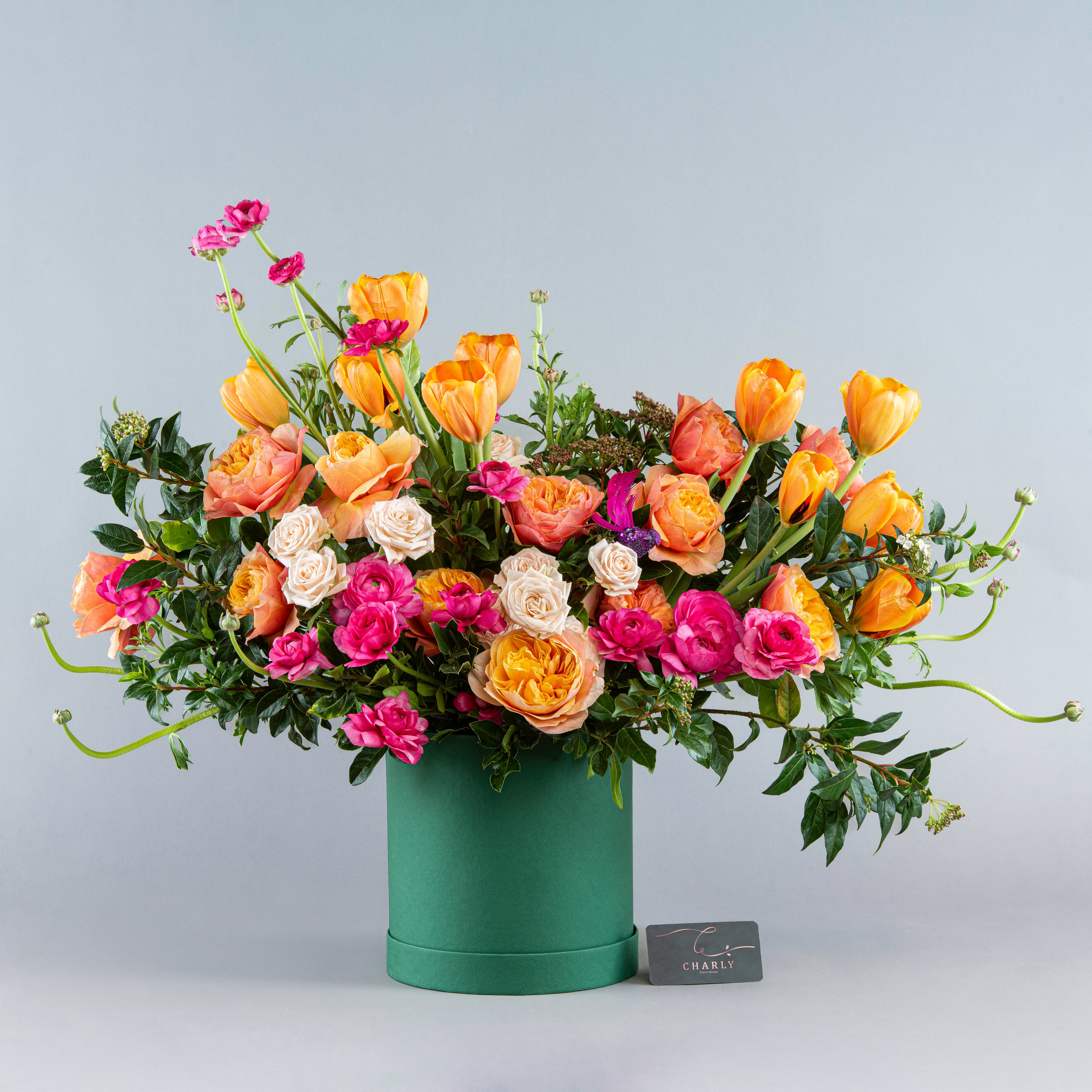 Sunset Splendor: Orange and Pink Floral Array in Green Box