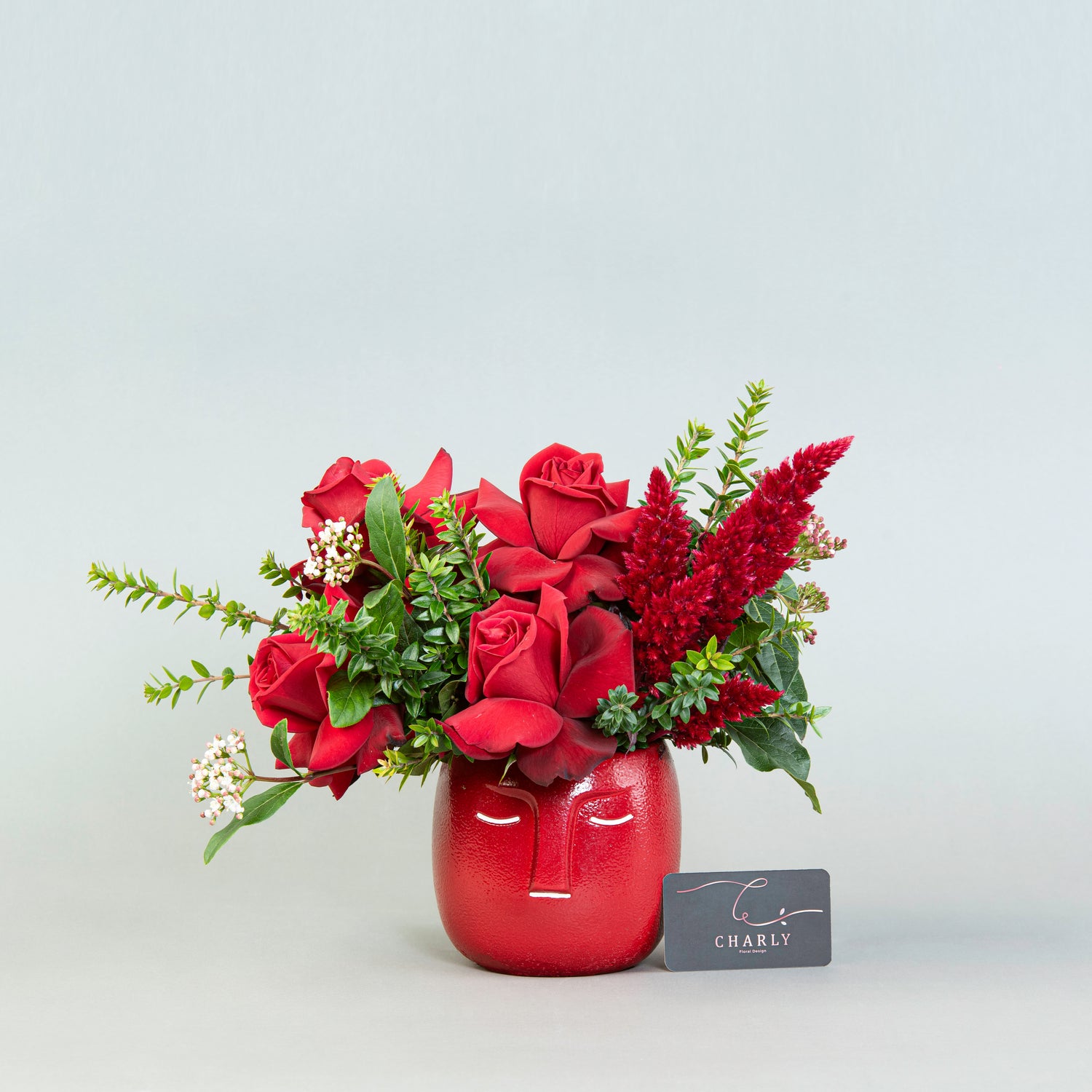 Crimson Contemplation: Red Roses and Celosia in Red Face Pot