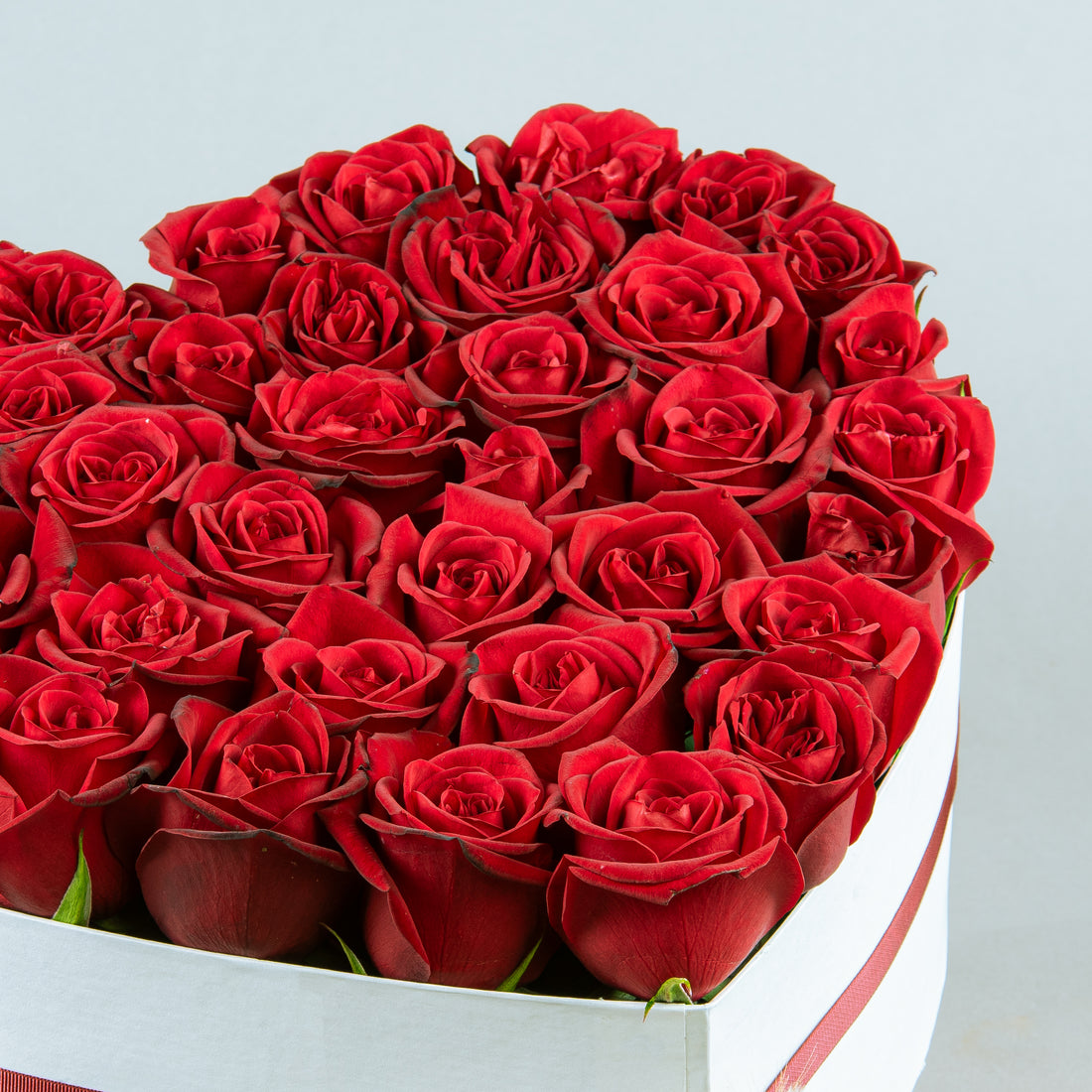 Crimson Heart Elegance: Red Roses in White Heart-Shaped Arrangement