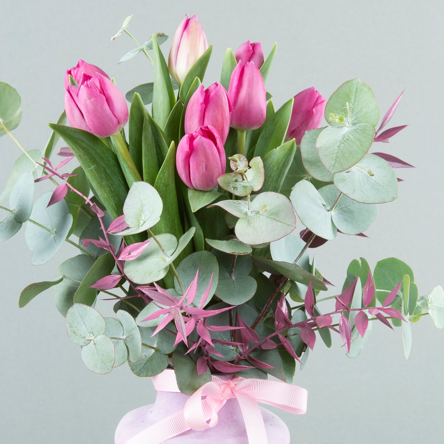 Enchanted Trio: Fuchsia Tulips in Three-Loop Purple Vase