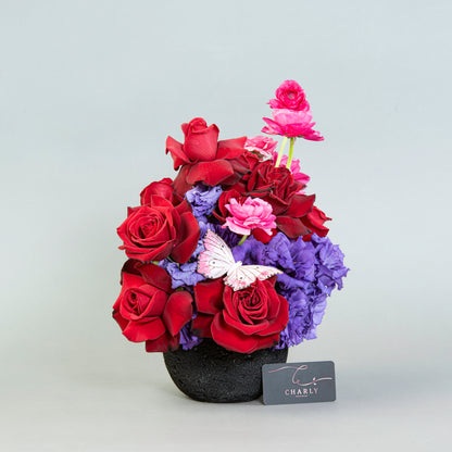 Lunar Allure: Red Roses and Vibrant Blooms in Black Moon Rock Vase