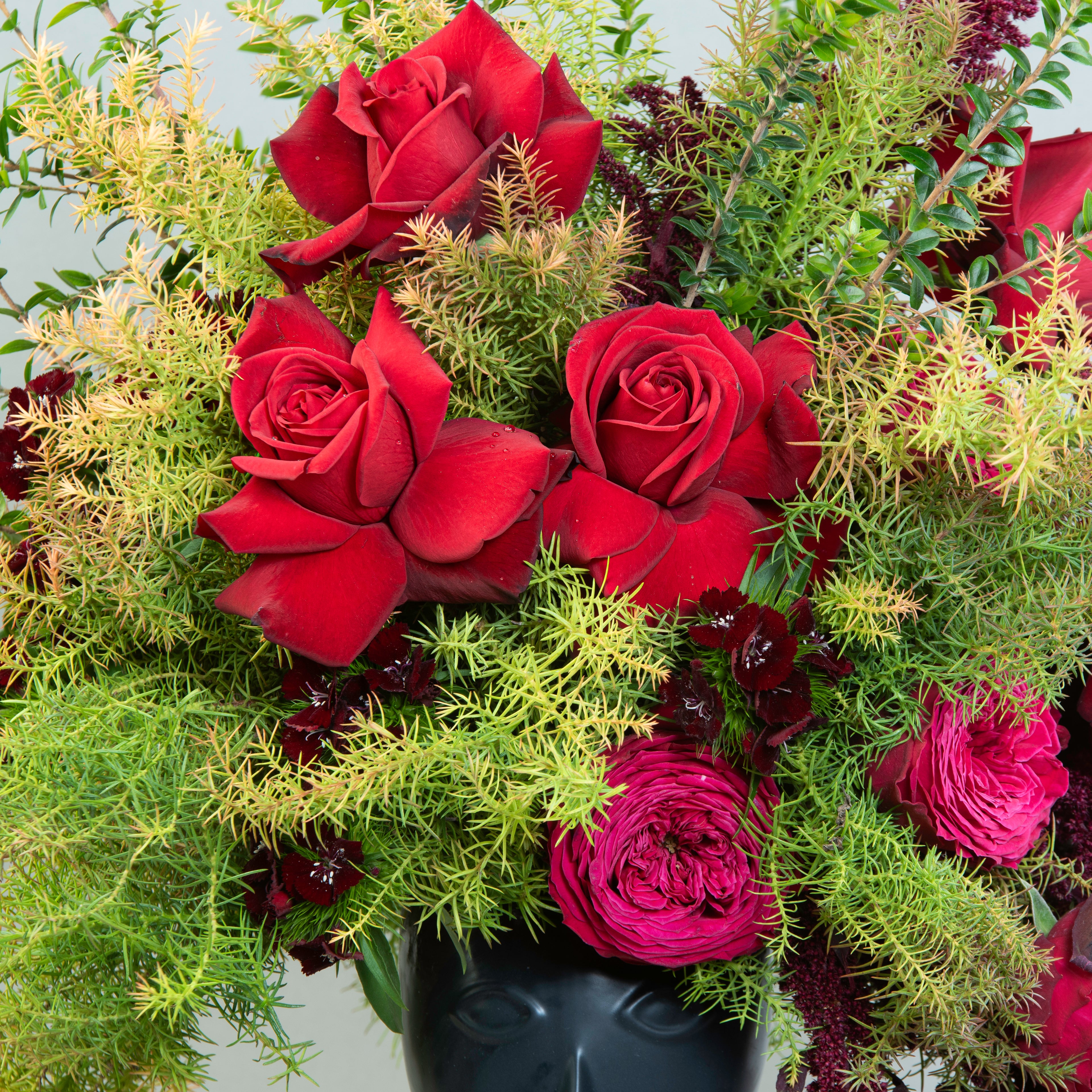 Mystic Floral Portrait: Red Roses and Amaranthus in Porcelain Face Vase