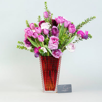 Regal Radiance: Purple Tulips and Ranunculus in Crystal Vase