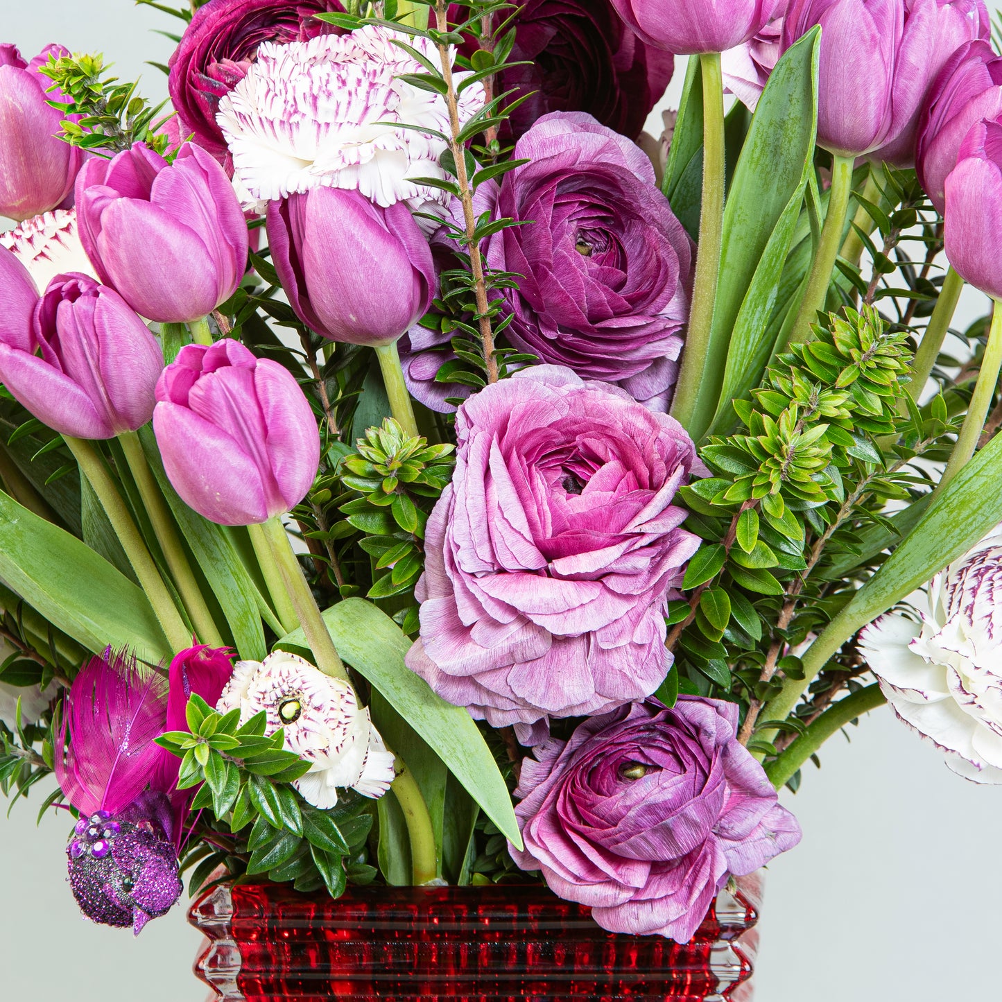 Regal Radiance: Purple Tulips and Ranunculus in Crystal Vase