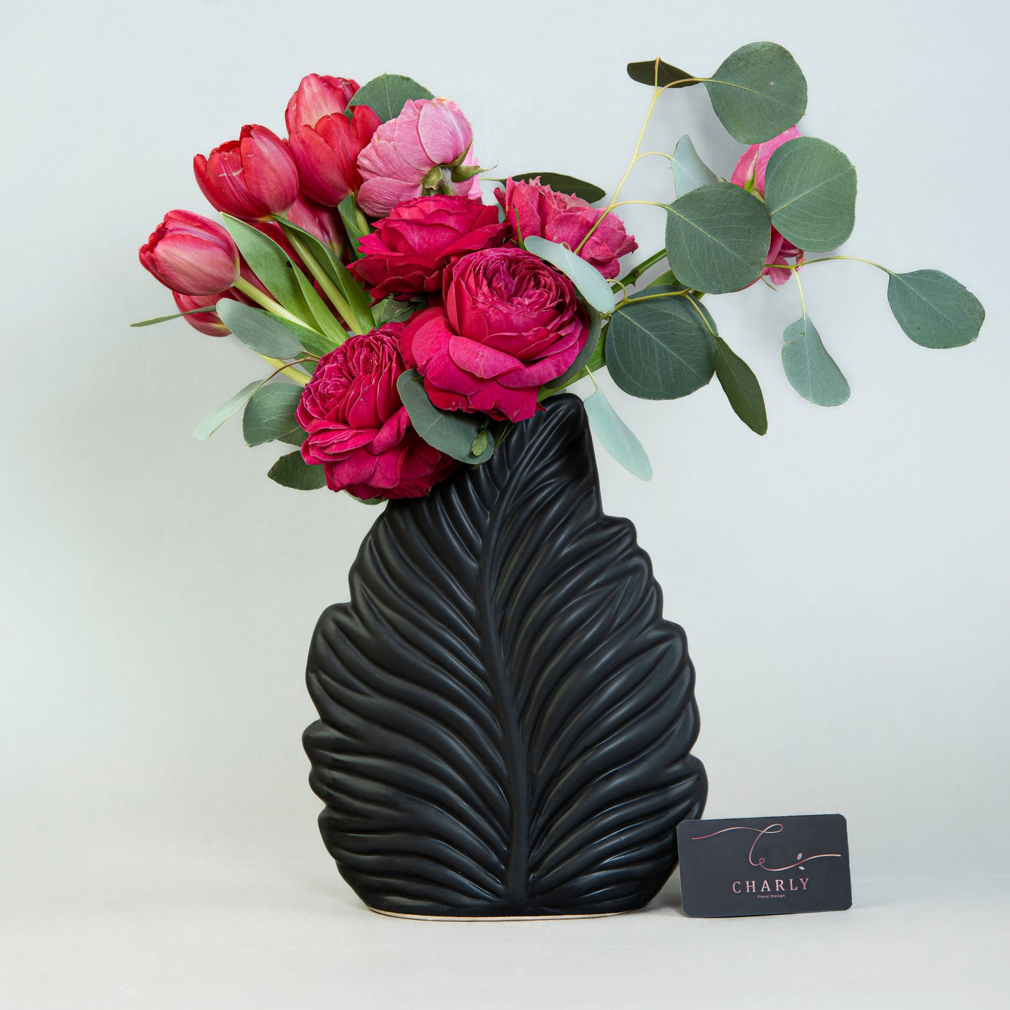 Crimson Flora Elegance: Red Tulips and Roses in Leaf-Shaped Vase