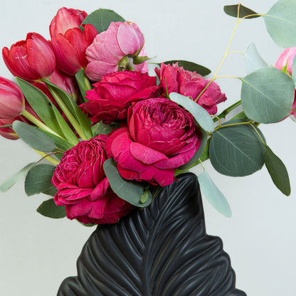 Crimson Flora Elegance: Red Tulips and Roses in Leaf-Shaped Vase